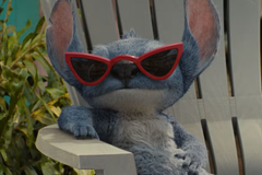 Stitch wearing red sunglasses in the 2025 live-action Lilo and Stitch movie
